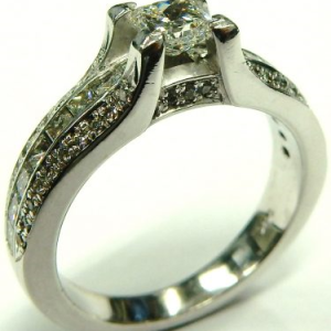 Estate Diamond Engagement Ring 
14 Karat White Estate Engagement Ring 
Finger Size 7 Gram Weight 6 
1 Center Diamond 0.45ct Shape: Princess; Clarity: VS2; Colour: F With 62 Various Shapes Diamonds 0.63 ctw 1.08