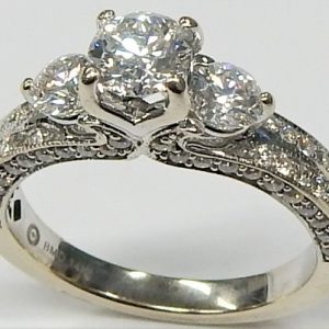 Estate Diamond Engagement Ring 
14 Karat White Estate Engagement Ring 
Finger Size 6.5 Gram Weight 4.1 
1 Center Canadian Diamond 0.52ct Shape: Round; Clarity: I1; Colour: G With 2 Round Canadian Diamonds 0.41 ctw and 76 Round Diamonds 0.56 ctw 1.49