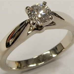 Estate Diamond Engagement Ring 
14 Karat White Estate Engagement Ring 
 Gram Weight 4.2 
1 Center Diamond 0.40ct Shape: Round; Clarity: SI1; Colour: H 0.4
