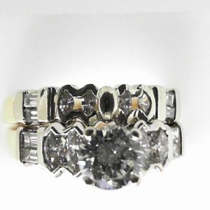 Estate Diamond Engagement Ring 
14 Karat Yellow/White Estate Engagement Ring 
Finger Size 6 Gram Weight 6.3 
1 Center Diamond 0.67ct Shape: Round; Clarity: SI1; Colour: H/I With 16 Various Shapes Diamonds 0.20 ctw 0.87