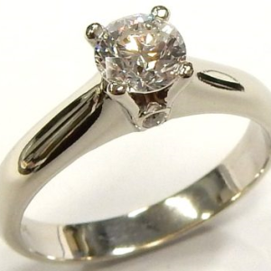 Estate Diamond Engagement Ring 
18 Karat White Estate Engagement Ring 
Finger Size 6.5 Gram Weight 4.4 
1 Center Diamond 0.56ct Shape: Round; Clarity: I1; Colour: E/F With 2 Round Diamonds 0.02 ctw 0.58