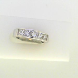 Diamond Wedding/Anniversary Ring 
18 Karat White Wedding/Anniversary Ring 
Finger Size 5 Gram Weight 6.4 
5 Center Diamonds Shape: Princess; Clarity: VS1; Colour: I 1.03