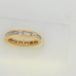 Estate Diamond Anniversary Ring 
14 Karat Yellow Estate Anniversary Ring Width 3.3mm 
Finger Size 5.75 Gram Weight 3 
17 Center Diamonds Shape: Baguette; Clarity: VS2; Colour: G/H 1.5