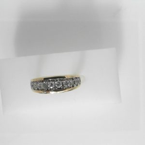 Estate Diamond Anniversary Ring 
14 Karat Yellow/White Estate Anniversary Ring Width 6.4mm 
Finger Size 7 Gram Weight 4.55 
10 Center Diamonds Shape: Round; Clarity: I2; Colour: I/J 0.45