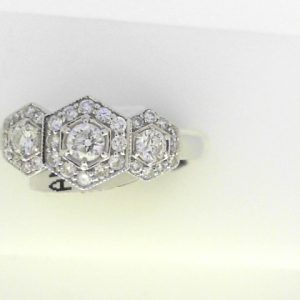 Diamond Dinner Ring - Women's 
14 Karat White Dinner Ring 
Finger Size 6.5 
1 Center Diamond 0.12ct Shape: Round CAD With 2 Round Diamonds 0.162 ctw and 30 Round Diamonds 0.22 ctw 0.502