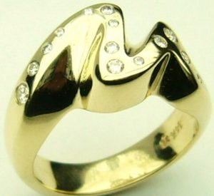 Estate Diamond Dinner Ring - Women's 
14 Karat Yellow Estate Dinner Ring Width 4.6mm 
Finger Size 5.25 Gram Weight 8.4 
14 Center Diamonds Shape: Round; Clarity: VS1; Colour: G 0.2