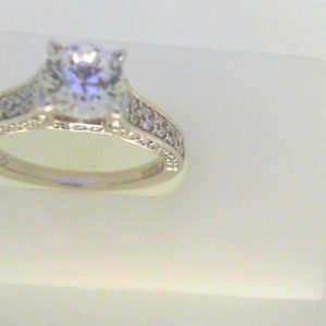 Diamond Semi-Mount Ring 
14 Karat White Ring 
Finger Size 6.25 
1 Center Cubic Zirconium 1.00ct Shape: Round Round Diamond 0.64 ctw 1.64