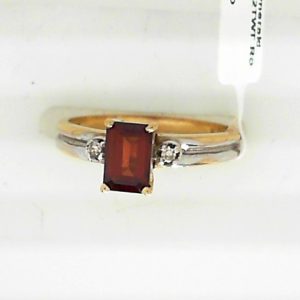 Garnet Ring 
10 Karat Yellow/White Garnet Ring With Finger Size 5.75 
Width 1.73mm Gram Weight 2.37 
1 Center Garnet Shape: Emerald With 2 Round Diamonds 0.02 ctw
