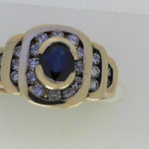 Sapphire Ring 
14 Karat Yellow Sapphire Ring With Finger Size 5.75 
Width 1.35mm Gram Weight 4.52 
1 Center Sapphire 0.65ct Shape: Oval With 22 Round Diamonds 0.44 ctw