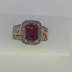 Tourmaline Ring 
14 Karat Rose/White Pink Tourmaline Ring With Finger Size 6 
Width 3.5mm Gram Weight 5.7 
1 Center Tourmaline Shape: Emerald; Colour: Pink With 40 Round Diamonds 0.50 ctw