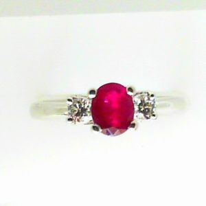 Ruby Ring 
14 Karat White Ruby Ring With Finger Size 6.5 
 
1 Center Ruby 0.67ct Shape: Round With 2 Round Diamonds 0.18 ctw