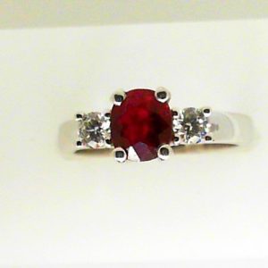 Ruby Ring 
18 Karat White Ruby Ring With Finger Size 6.5 
 
1 Center Ruby 1.09ct Shape: Round With 2 Round Diamonds 0.29 ctw