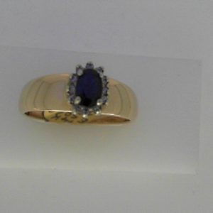 Sapphire Estate Ring 
14 Karat Yellow Sapphire Ring With Finger Size 10 
Width 3mm Gram Weight 5.99 
1 Center Sapphire Shape: Oval With 12 Round Diamonds 0.10 ctw