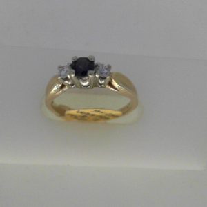 Sapphire Estate Ring 
10 Karat Yellow/White Sapphire Ring With Finger Size 6.5 
Width 1.85mm Gram Weight 2.7 
1 Center Sapphire Shape: Round With 2 Round Diamonds 0.13 ctw