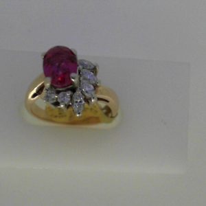 Tourmaline Estate Ring 
14 Karat Yellow Red Tourmaline Ring With Finger Size 6.5 
Width 2.61mm Gram Weight 4.25 
1 Center Tourmaline Shape: Oval; Colour: Red With 3 Round Diamonds and 4 Marquise Diamonds
