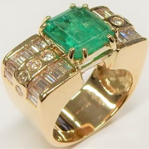 Emerald Estate Ring 
14 Karat Yellow Emerald Ring With Finger Size 5 
Width 8.3mm Gram Weight 10.6 
1 Center Emerald 3.20ct Shape: Emerald With 8 Round Diamonds 0.24 ctw and 8 Baguette Diamonds 1.04 ctw