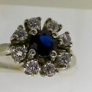 Sapphire Estate Ring 
18 Karat White Sapphire Ring With Finger Size 6.5 
 Gram Weight 3.04 
1 Center Sapphire 0.33ct Shape: Round With 8 Round Diamonds 0.33 ctw