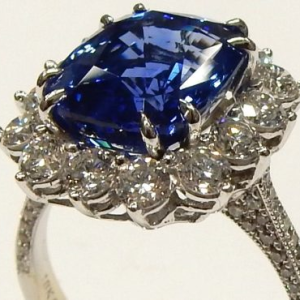 Diamonds Estate Ring 
18 Karat White H Diamonds Ring With Finger Size 8.5 
Width 2.5mm Gram Weight 6.3 
14 Center Diamonds Shape: Round; Clarity: SI2; Colour: H With 68 Round Diamonds 0.25 ctw and 1 Cushion Sapphire 7.15 ctw