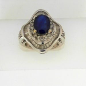 Diamonds Estate Ring 
14 Karat White I Diamonds Ring With Finger Size 5.75 
 Gram Weight 7.2 
22 Center Diamonds Shape: Round; Clarity: I1; Colour: I With 40 Baguette Diamonds and 1 Oval Sapphire 1.15 ctw