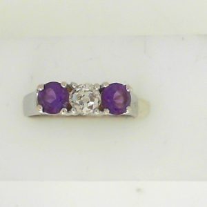 Diamond Estate Ring 
14 Karat White J Diamond Ring With Finger Size 7 
 Gram Weight 3.01 
1 Center Diamond 0.30ct Shape: Old Mine Cut; Clarity: VS1; Colour: J With 2 Round Amethysts