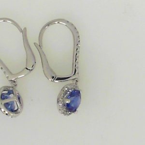 Earrings with Sapphires 
18 Karat White Sapphires Earrings 
 
2 Center Sapphires Shape: Round Round Diamond 0.24 ctw