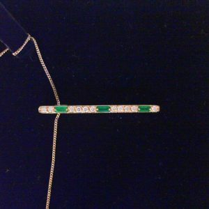 Emeralds Pendant 
14 Karat Yellow Emeralds Pendant 
Gram Weight 4.56 Chain Style: Curb 14 Karat Yellow Length: 18in 
3 Center Emeralds Shape: Baguette With 11 Round Diamonds 0.33 ctw