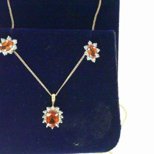 Citrine Pendant 
14 Karat Yellow/White Citrine Pendant 
 Chain Style: Curb 14 Karat Yellow Length: 18in 
1 Center Citrine Shape: Oval Round Diamond 0.11 ctw