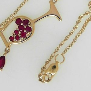 Rubies Pendant 
14 Karat Yellow Rubies Pendant 
Gram Weight 3.57 Chain Style: Cable Link 14 Karat Yellow Length: 18in 
9 Center Rubies Shape: Various Shapes