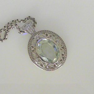 Aqua Estate Pendant 
14 Karat White Aqua Pendant 
 Chain Style: No Chain 
1 Center Aqua 11.79ct Shape: Oval With 29 Round Diamonds