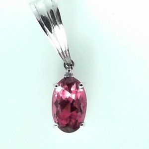 Tourmaline Estate Pendant 
18 Karat White Pink Tourmaline Pendant 
Gram Weight 3.1 
1 Center Tourmaline 4.10ct Shape: Oval; Colour: Pink With 1 Round Diamond