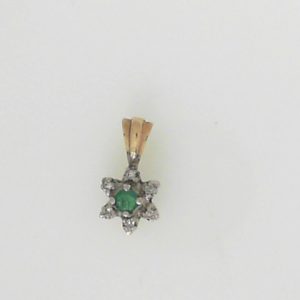 Emerald Estate Pendant 
14 Karat Yellow Emerald Pendant 
Gram Weight 0.81 Chain Style: No Chain 
1 Center Emerald Shape: Round With 6 Round Diamonds