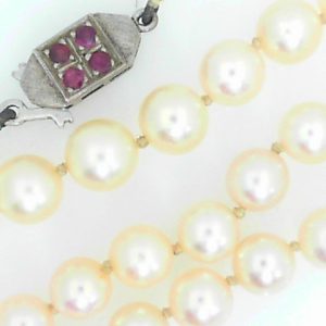 Rubies Estate Pendant 
18 Karat White Rubies Pendant 
 Chain Style: Bead 18 Karat White 
4 Center Rubies Shape: Round With 67 Round Pearls