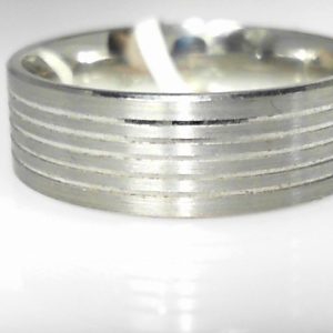 White 10 Karat Satin Band Ring 
Size: 10 
Gram Weight 7.02 gr